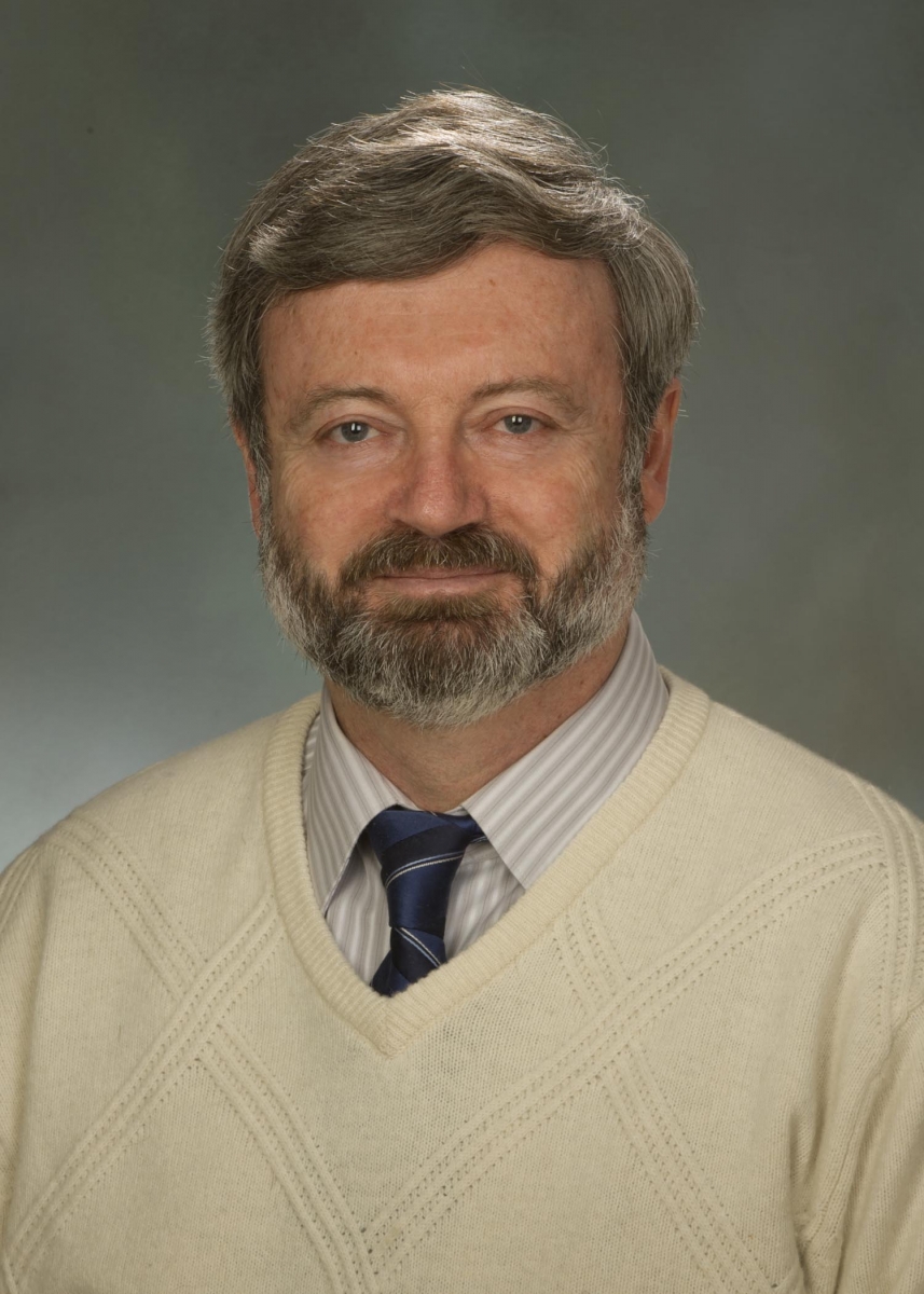 A color portrait of Dr. Alexander Karatayev in a sweater and tie