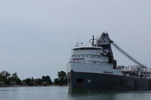 The front end of a freighter boat called Saginaw motors by the shore