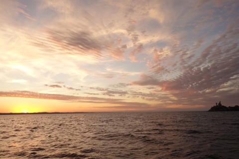 A variety of clouds at sunset on a lake.