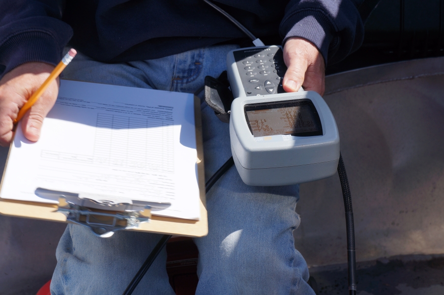 Picture of a person's lap with a clipboard and an instrument