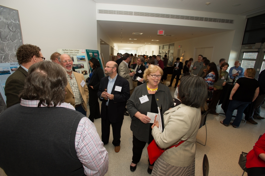 Many guests mingle at a reception.