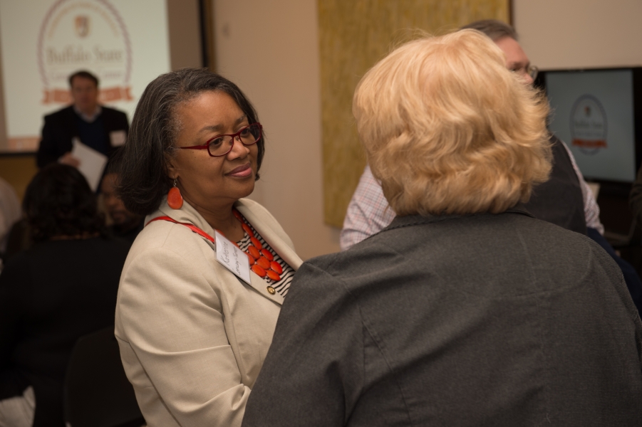 Two people talking at an event