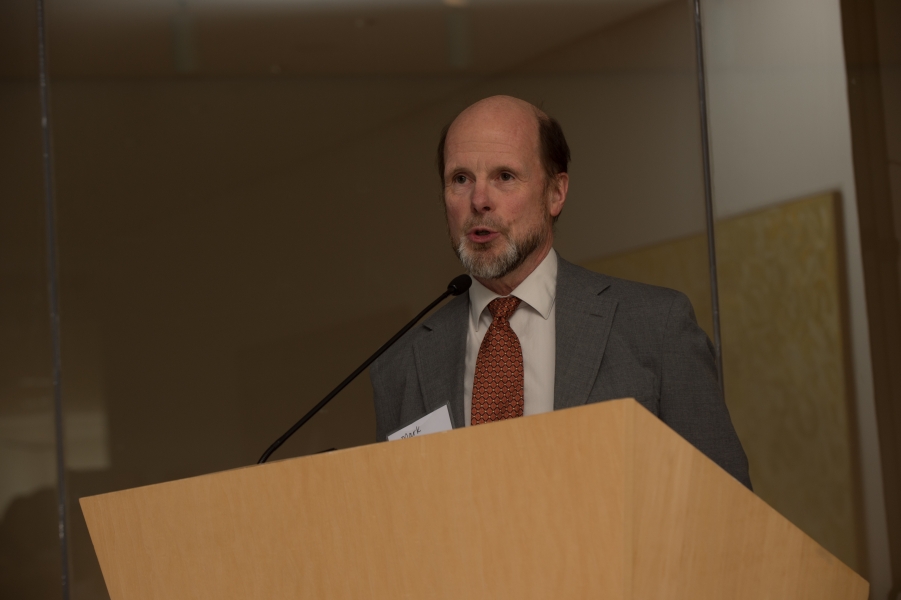 a person with "Mark" on their name tag talking at a podium