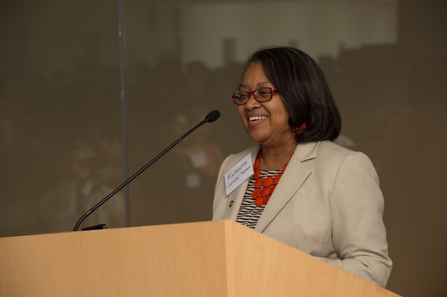 a person with name tag "Katherine Conway-Turner" talking at a podium