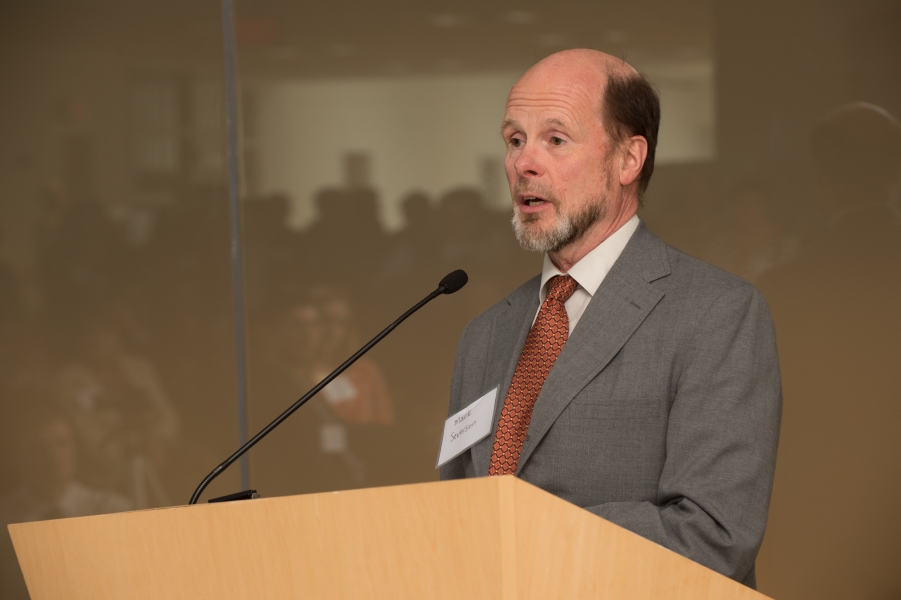 a person with "Mark Severson" on his name tag talking at a podium