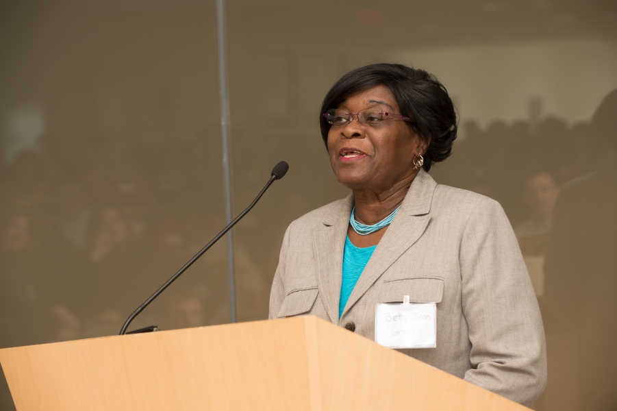 A person with name tag "Betty Jean Grant" talking at a podium