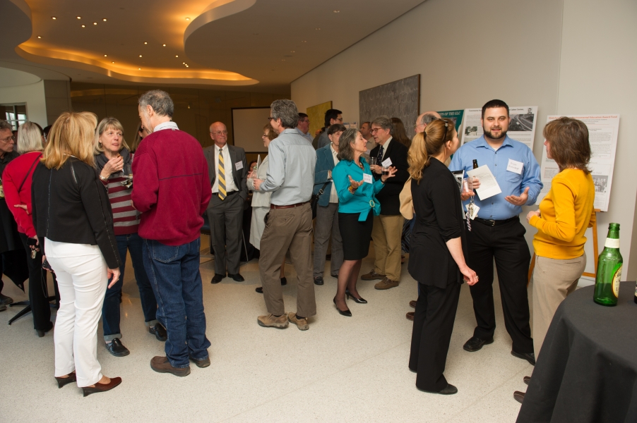 Many guests mingle during at an event at a gallery