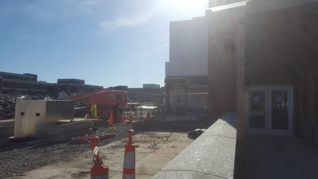 The same view as the previous picture, but the building part is gone. There is a cherry-picker where the building was, and some new equipment is in the foreground.