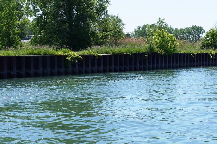 A metal bulkhead wall along the edge of the water.