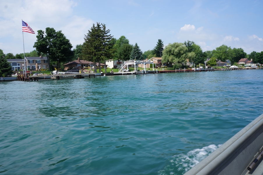 Many houses with docks on the shoreline of the water.