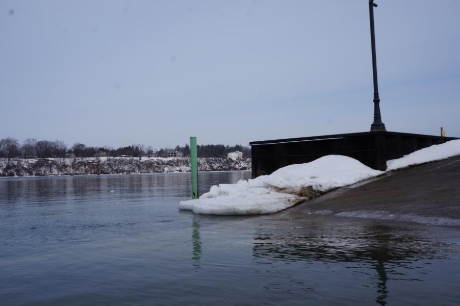 ice next to the water at a boat ramp