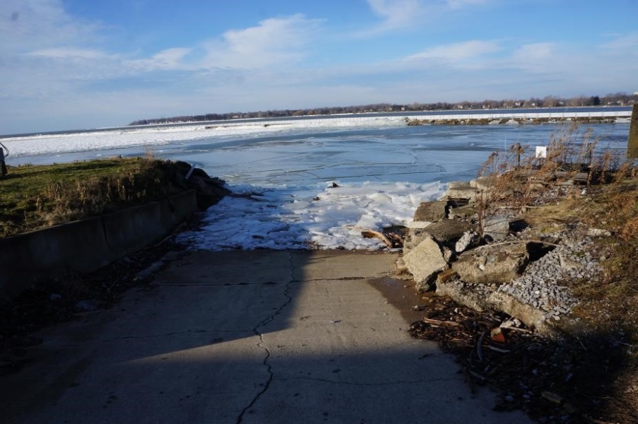 A boat ramp with ice piled about halfway up.