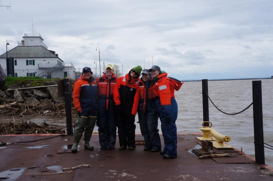 Five students from the fisheries class pose on the dock in their flotation suits.