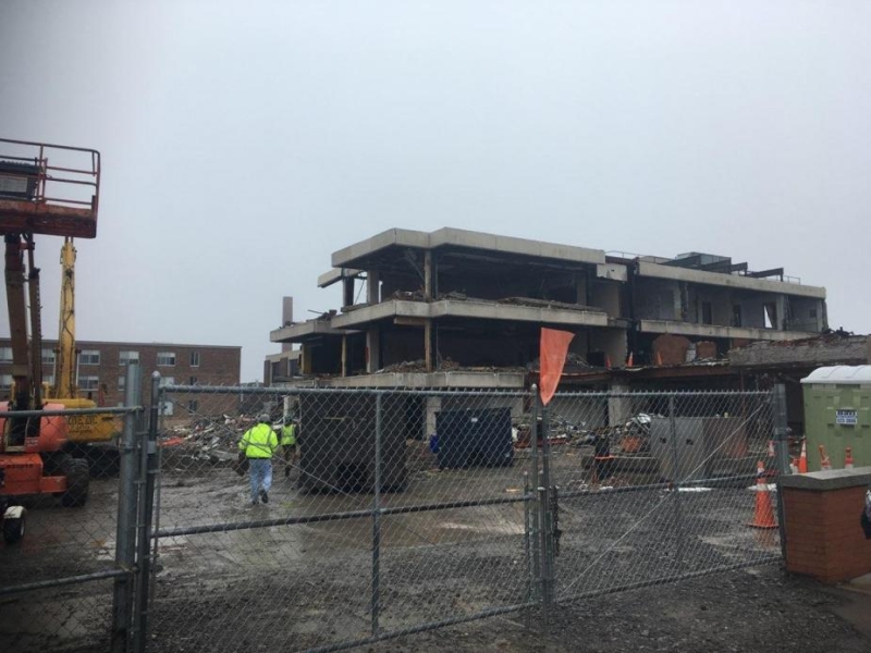 A construction site with a partly demolished building.