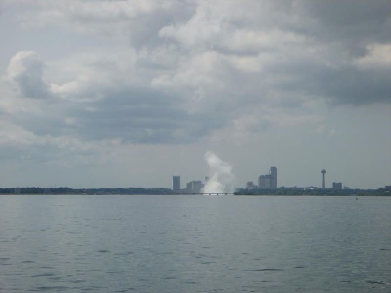 A plume of mist rises from the water in the distance.