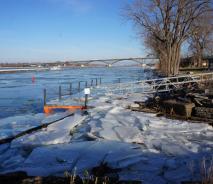A boat dock covered with broken sheets of ice.